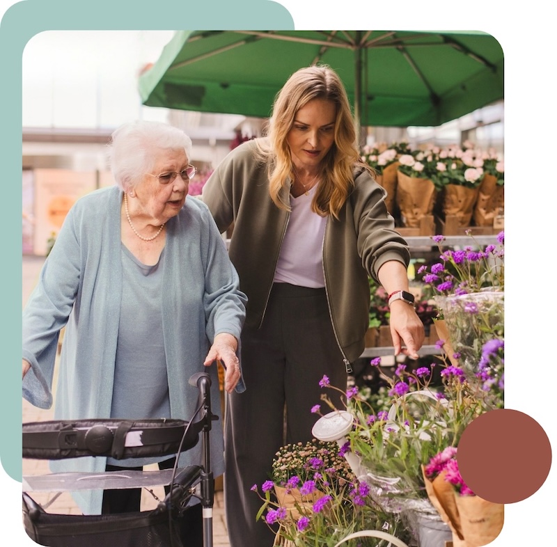 Seniorenbetreuung beginnt bei uns mit Vertrauen - Saigal Care Senioring und Saigal Care Gründerin Katrin am Blumenstand